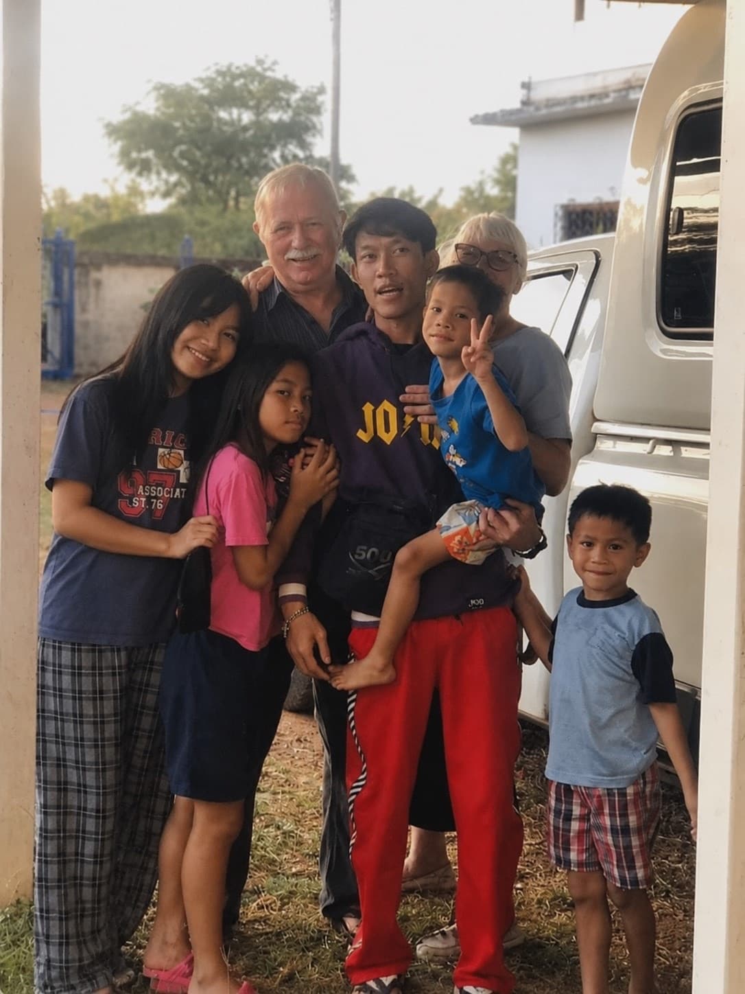 Randy with some of the kids by the truck, everyone smiling